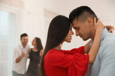 Photo of Lovely young couple dancing together at party