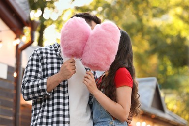 Photo of Stylish couple with cotton candies in park