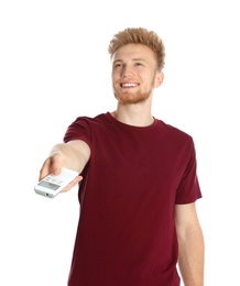 Photo of Young man with air conditioner remote on white background