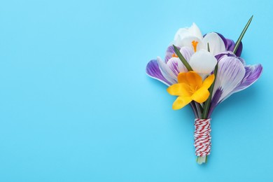 Photo of Beautiful crocus bouquet on turquoise background, top view. Space for text