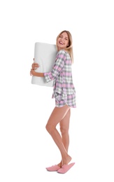 Photo of Young woman in pajamas embracing pillow on white background