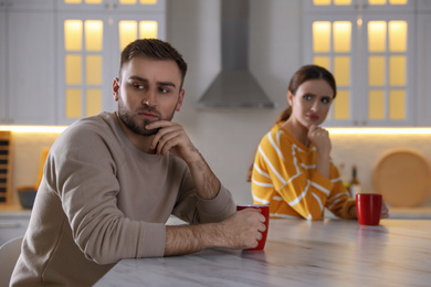 Photo of Young couple quarreling at home. Jealousy in relationship