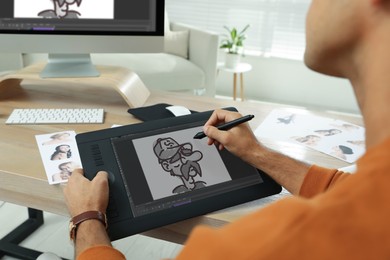 Image of Animator using graphic tablet and computer, closeup. Illustration on screen