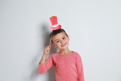 Image of Cute little boy with red hat prop on white background. Christmas celebration
