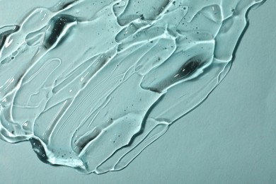 Photo of Transparent cosmetic gel on light blue background