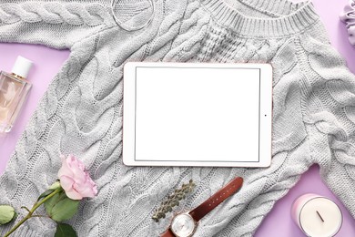 Photo of Flat lay composition with modern tablet on violet background. Space for text