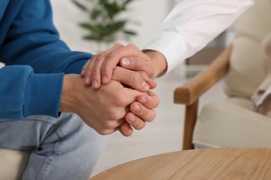 Photo of Psychologist working with teenage boy in office, closeup. Teenager problems
