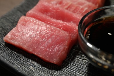 Photo of Tasty sashimi (pieces of fresh raw tuna) on plate, closeup