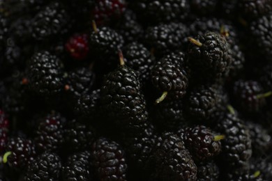 Photo of Heap of delicious ripe black mulberries as background, closeup
