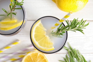Photo of Flat lay composition with lemon and rosemary cocktail on light table
