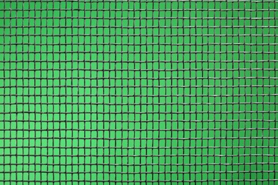 Photo of Closeup view of mosquito window screen on green background