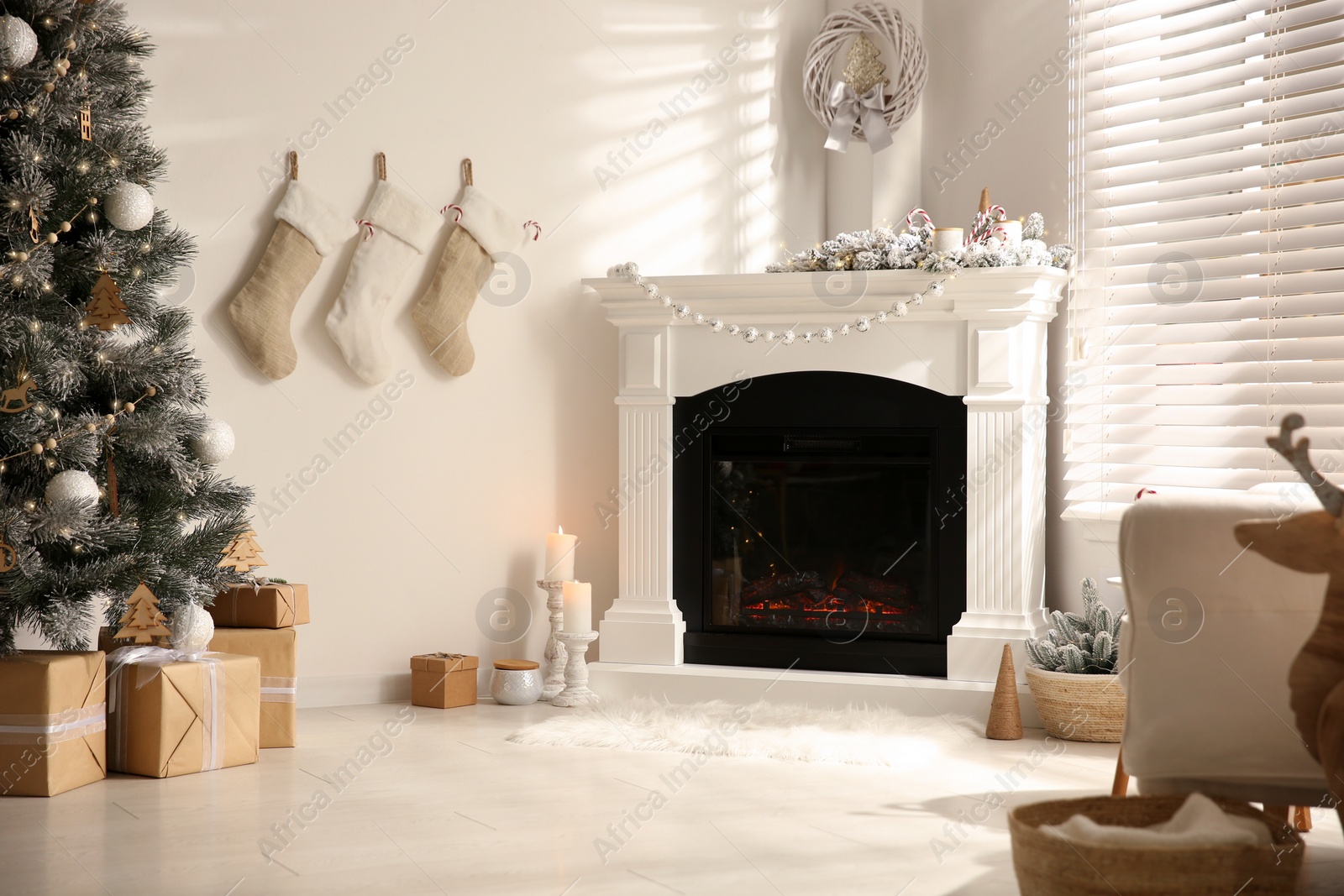 Beautiful living room interior with decorated Christmas tree and modern fireplace Photo of Beautiful living room interior with decorated Christmas tree and modern fireplace