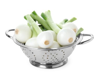 Photo of Colander with green spring onions isolated on white