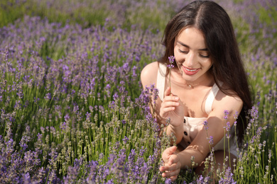 Photo of Young woman in lavender field on summer day