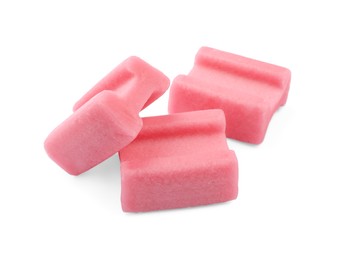 Photo of Tasty pink chewing gums on white background