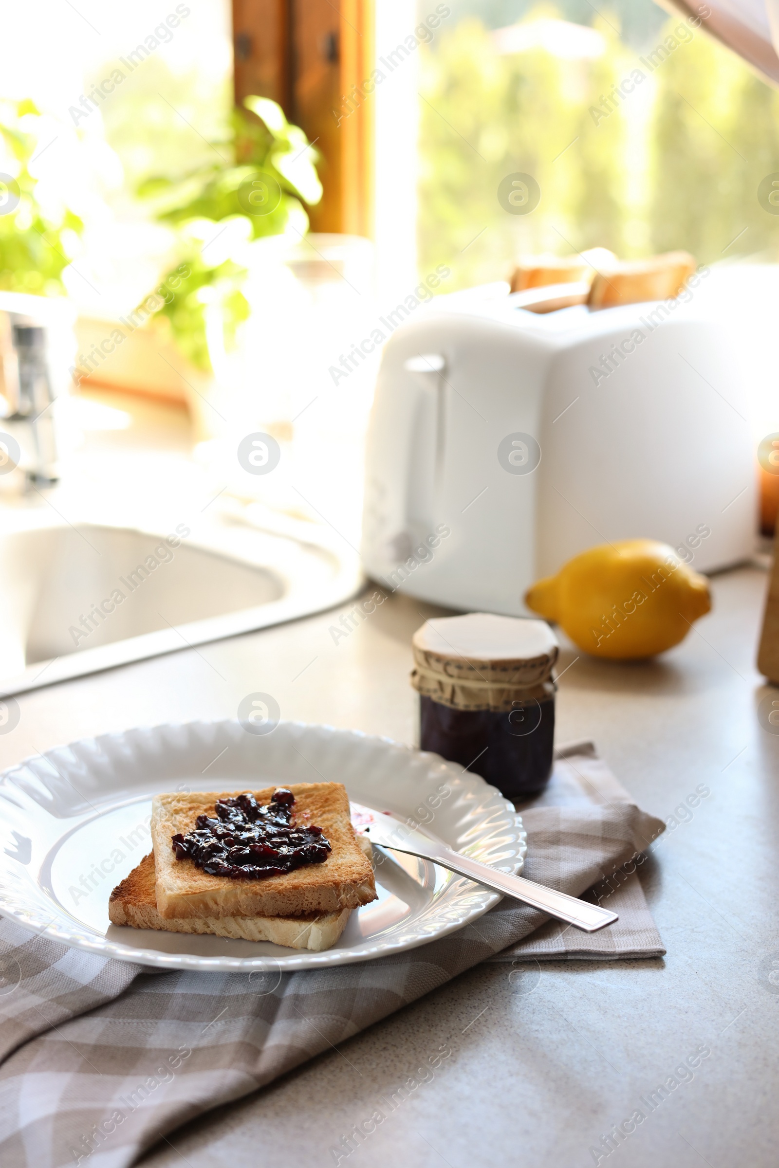 Photo of Tasty toasts with jam on countertop in kitchen, space for text