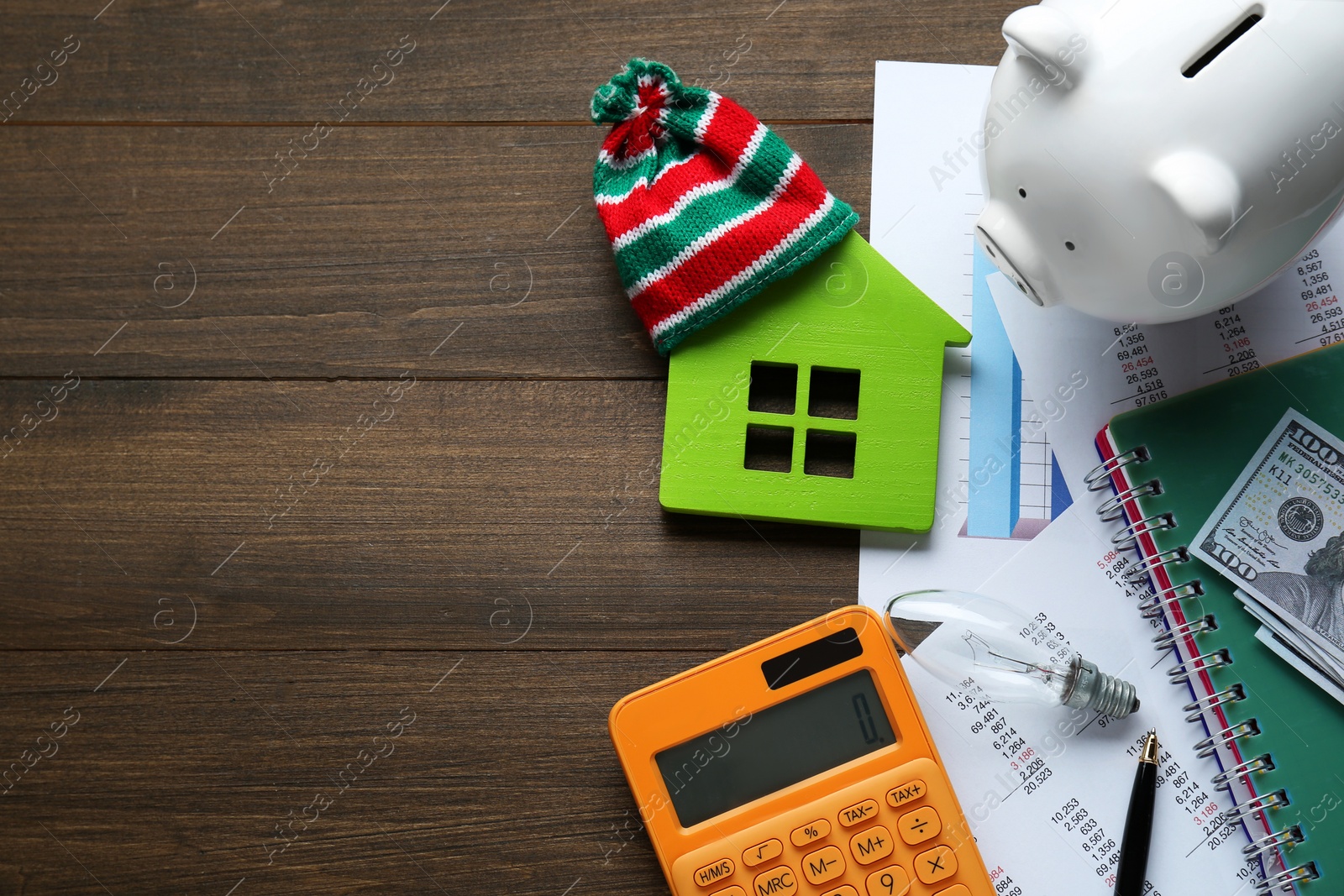 Photo of Flat lay composition with piggy bank and calculator on wooden table, space for text. Paying bills concept