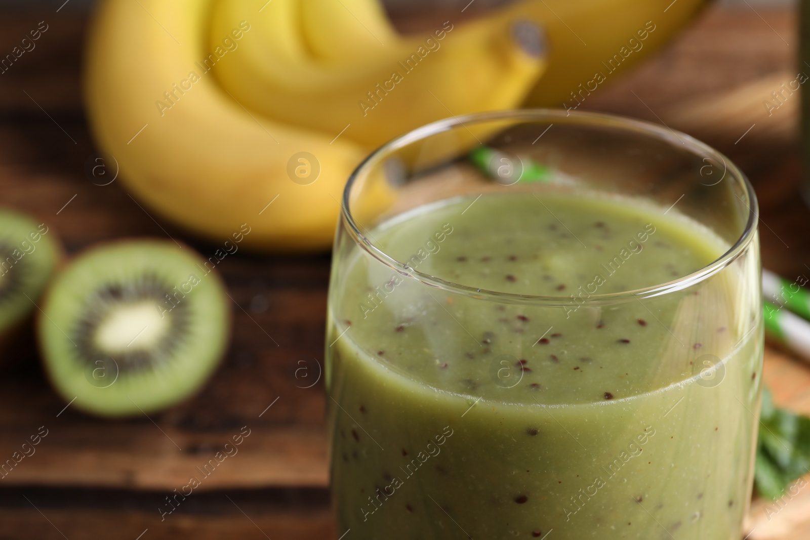 Photo of Delicious kiwi smoothie in glass, closeup view