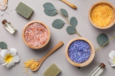 Flat lay composition with spa products and eucalyptus branches on grey background