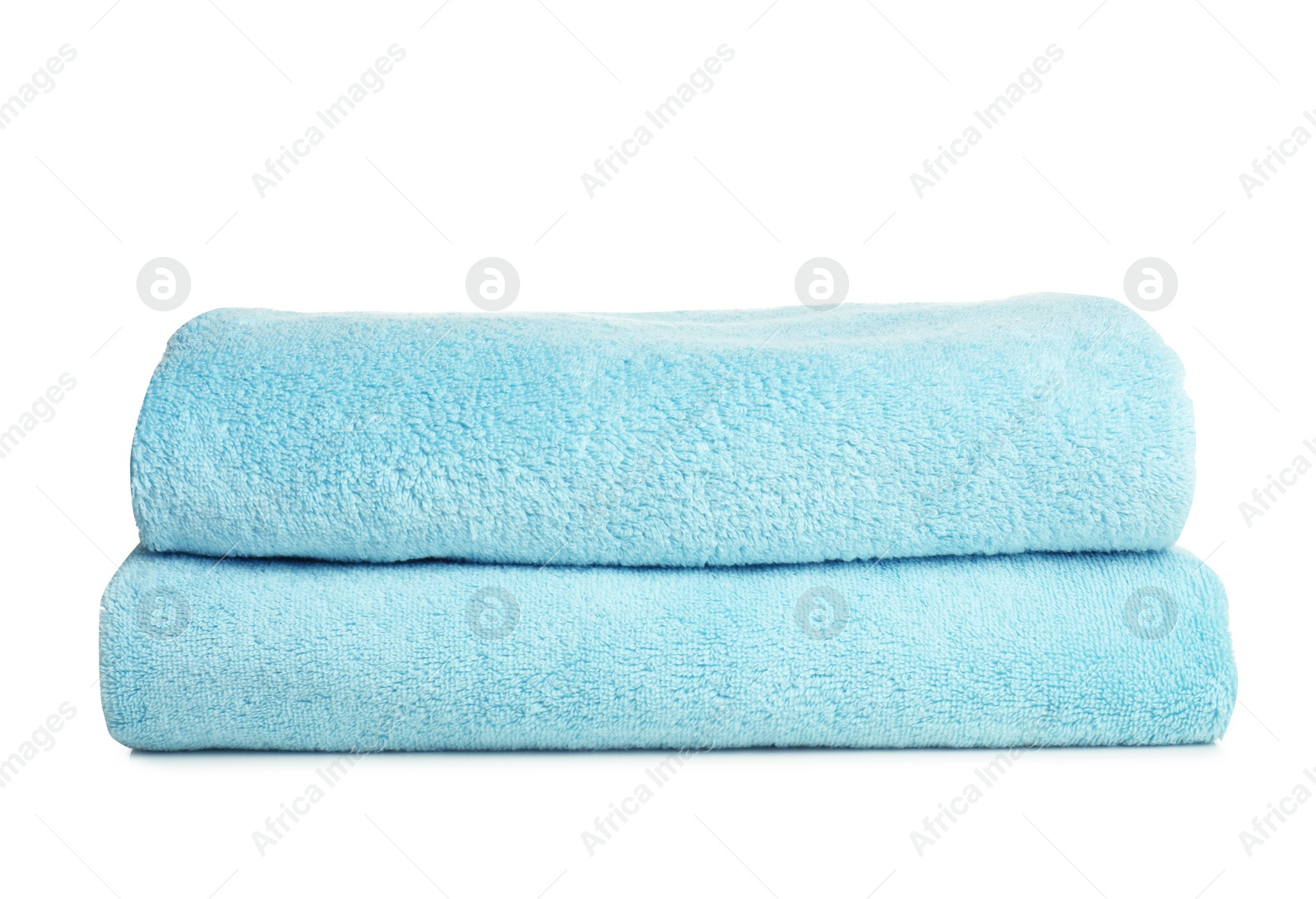 Photo of Folded soft terry towels on white background