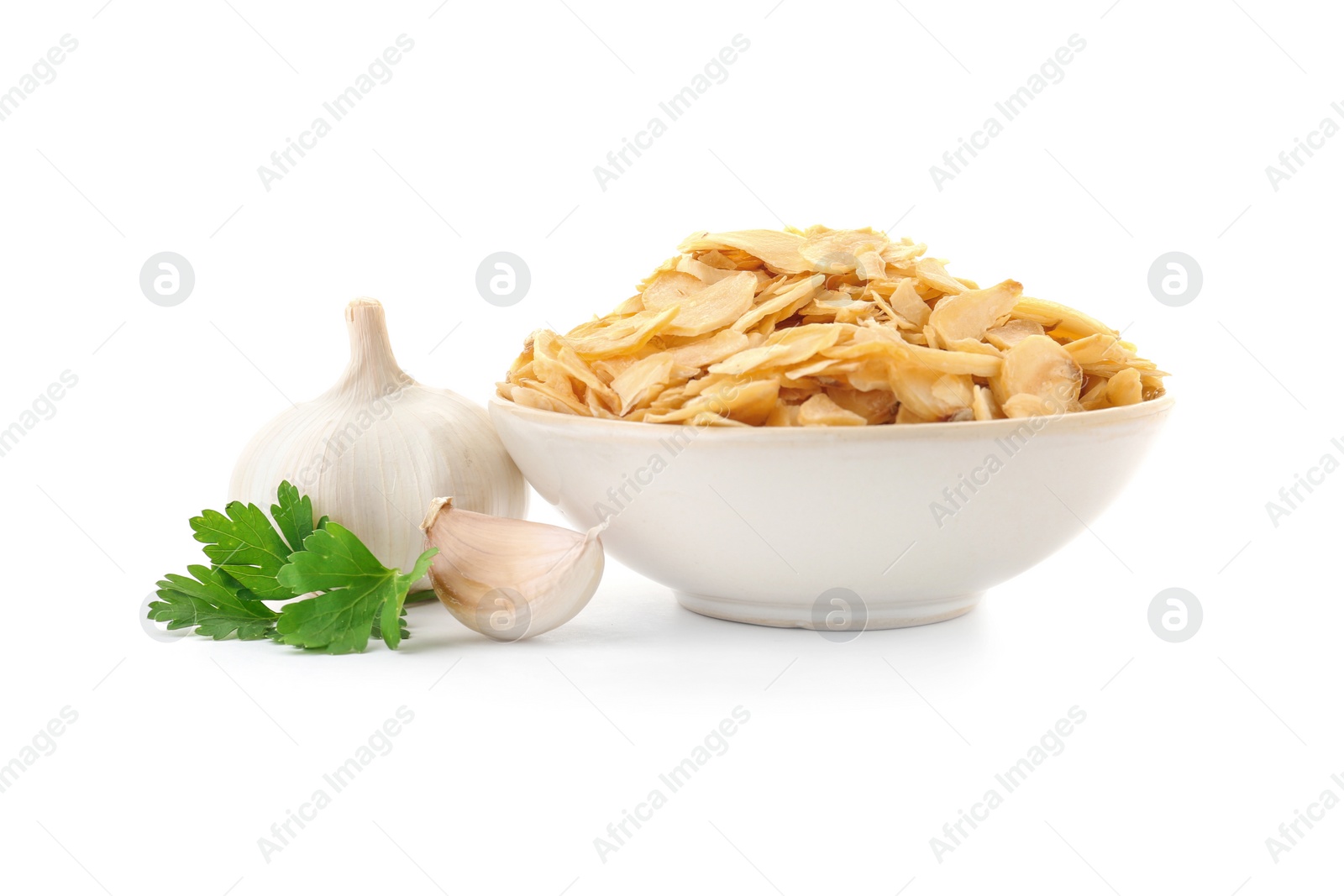 Photo of Bowl of dried garlic flakes and parsley on white background