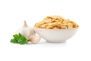 Photo of Bowl of dried garlic flakes and parsley on white background