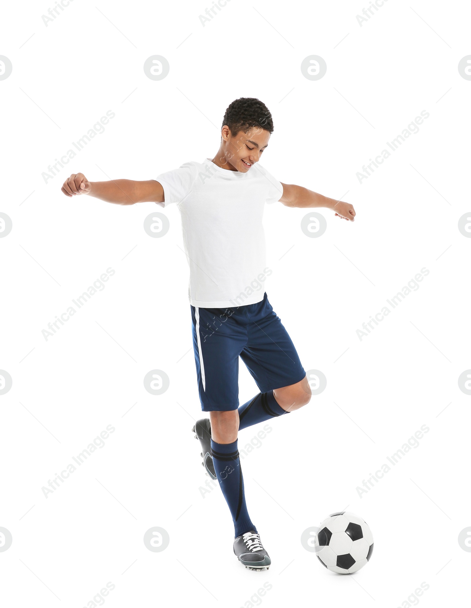 Photo of Teenage African-American boy playing football on white background