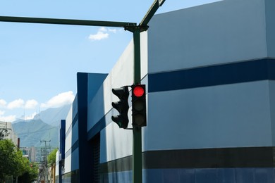 Photo of Traffic lights on city street. Road rules