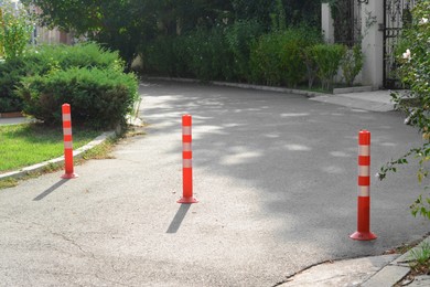 Photo of Traffic plastic poles on asphalt road outdoors
