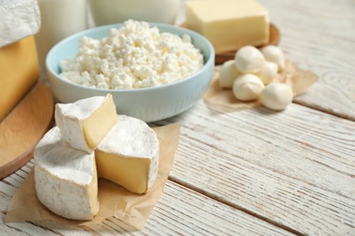 Different delicious dairy products on white wooden table