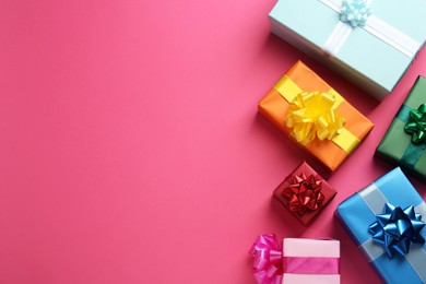 Photo of Many colorful gift boxes on pink background, flat lay. Space for text