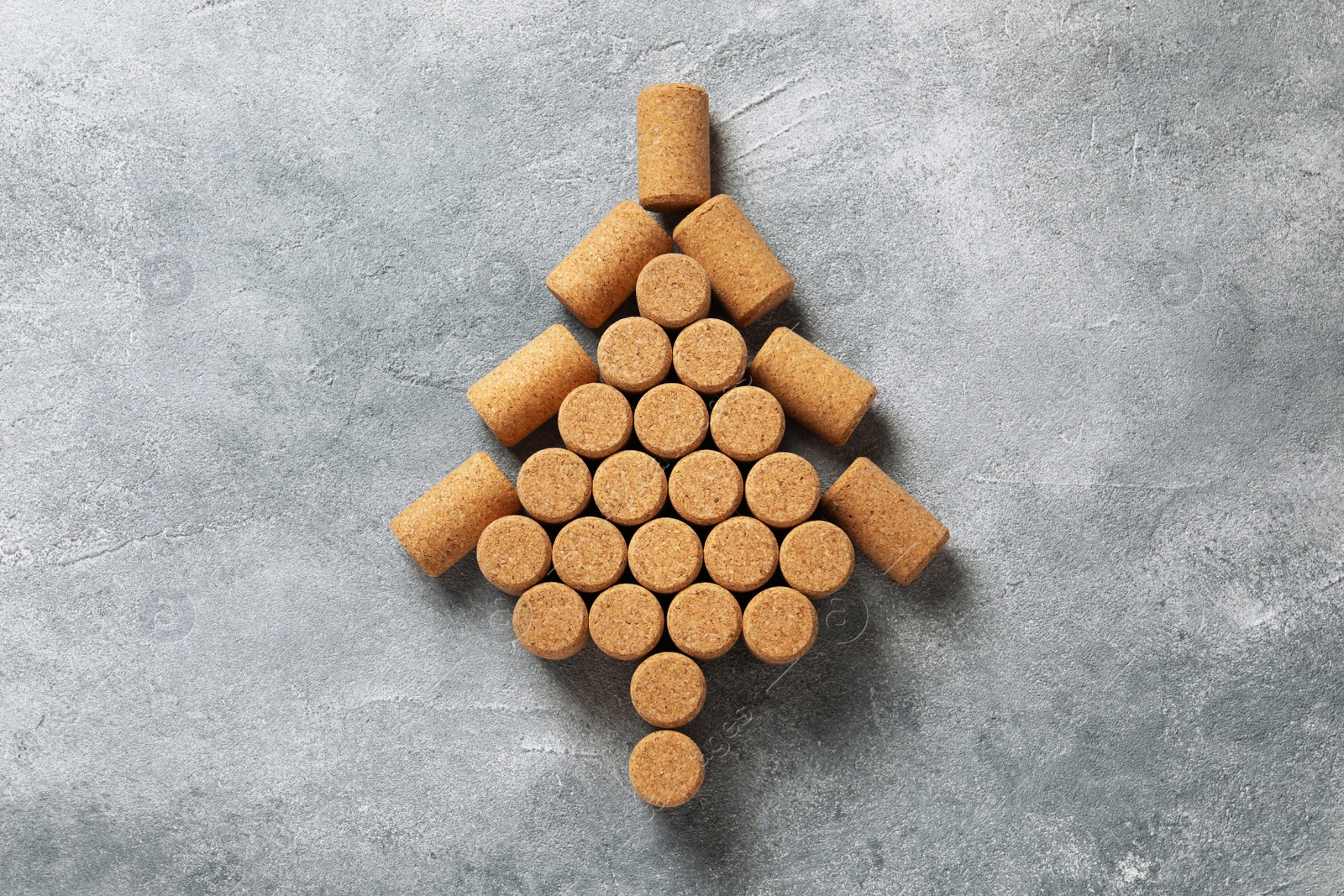 Photo of Christmas tree made of wine corks on grey table, top view