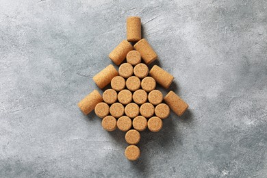 Christmas tree made of wine corks on grey table, top view