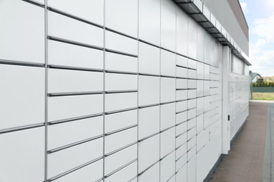 Photo of Modern parcel locker with many postal boxes outdoors