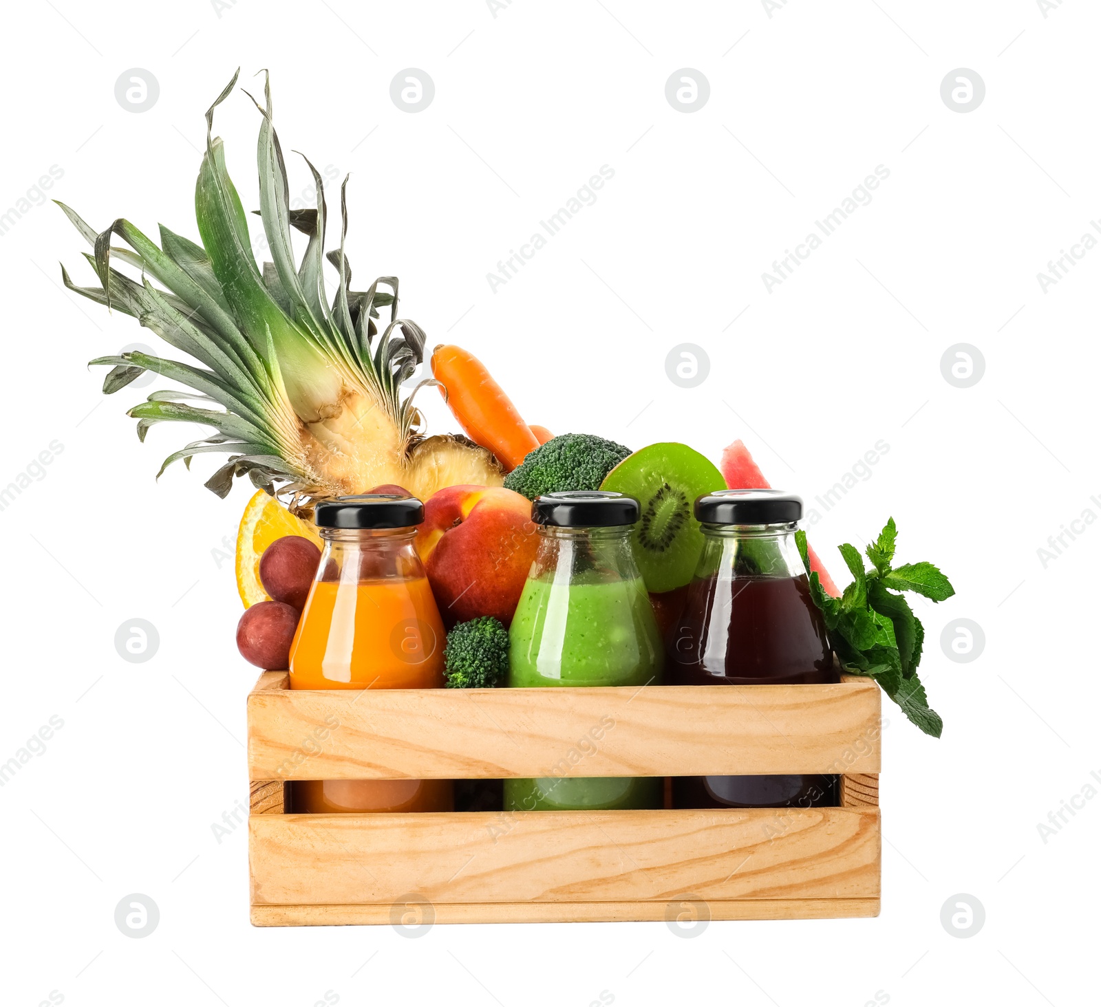 Photo of Bottles with delicious colorful juices and fresh ingredients in wooden crate on white background