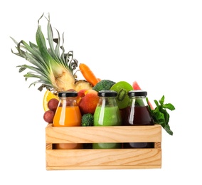 Photo of Bottles with delicious colorful juices and fresh ingredients in wooden crate on white background
