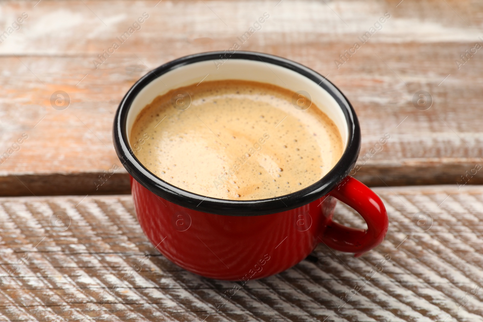 Photo of Cup of aromatic coffee on wooden table, closeup