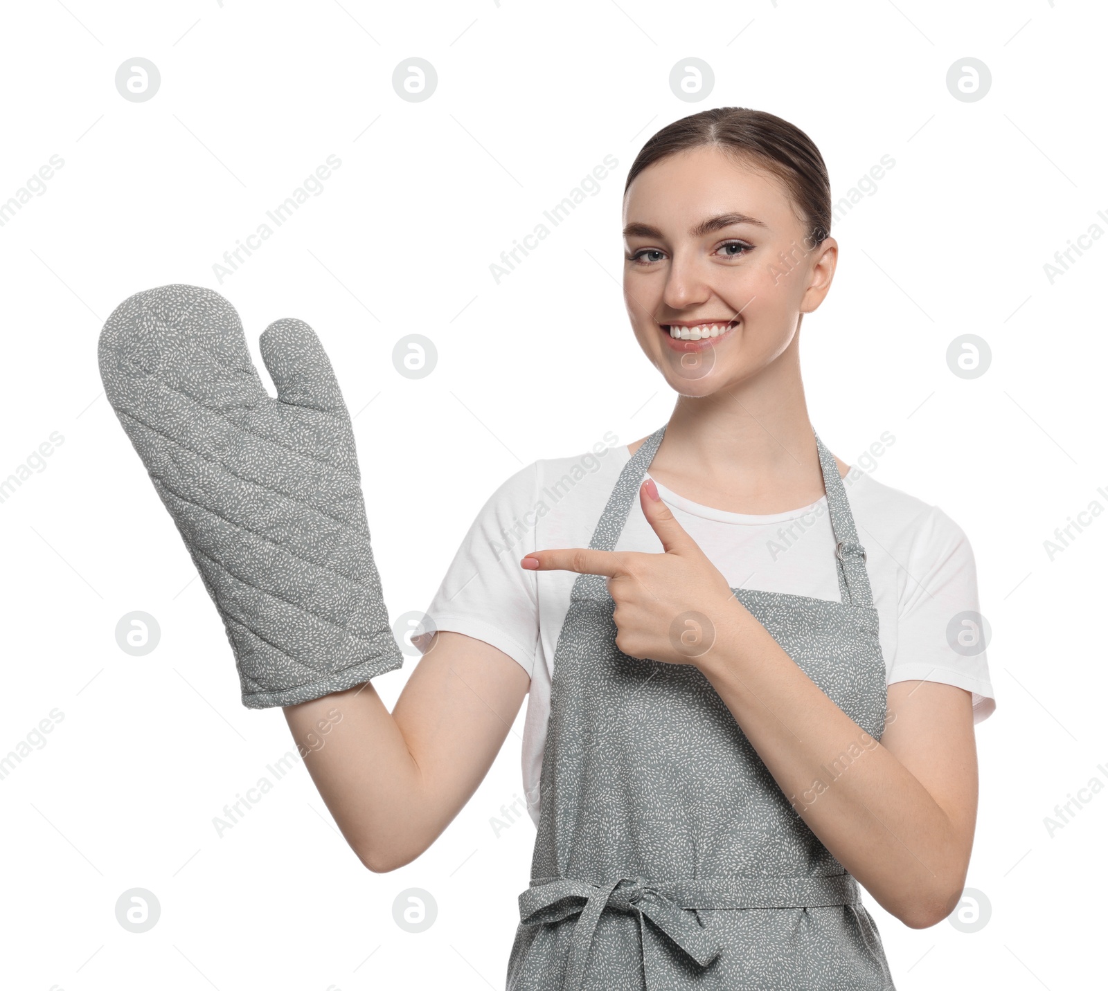 Photo of Beautiful young woman in clean apron with pattern and oven glove on white background