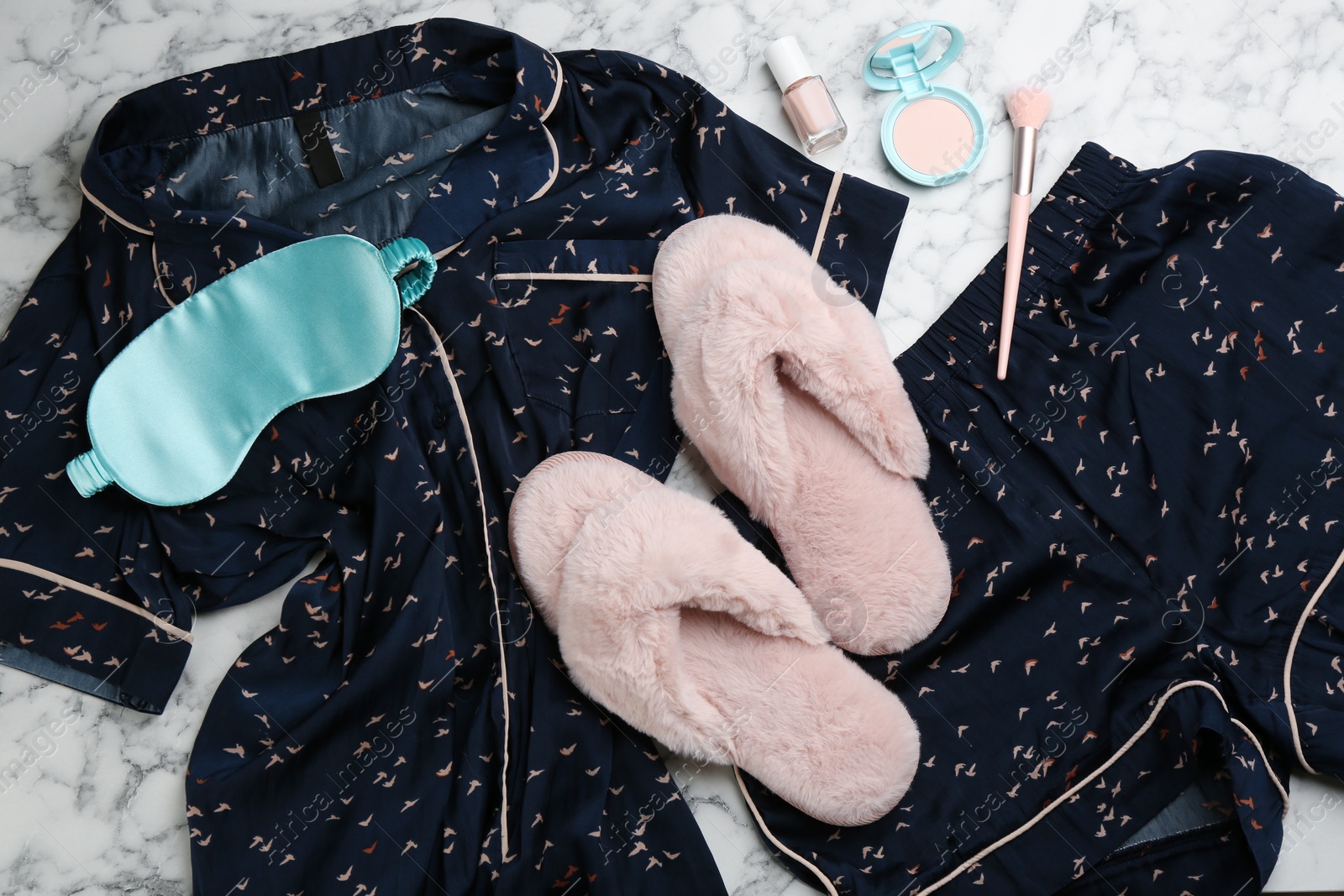 Photo of Flat lay composition with fluffy slippers and pajamas on white marble background. Comfortable home outfit