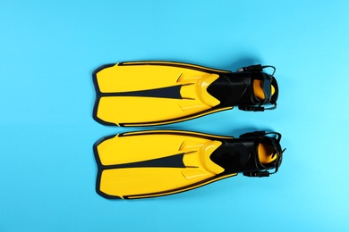 Photo of Swimming flippers on color background, top view