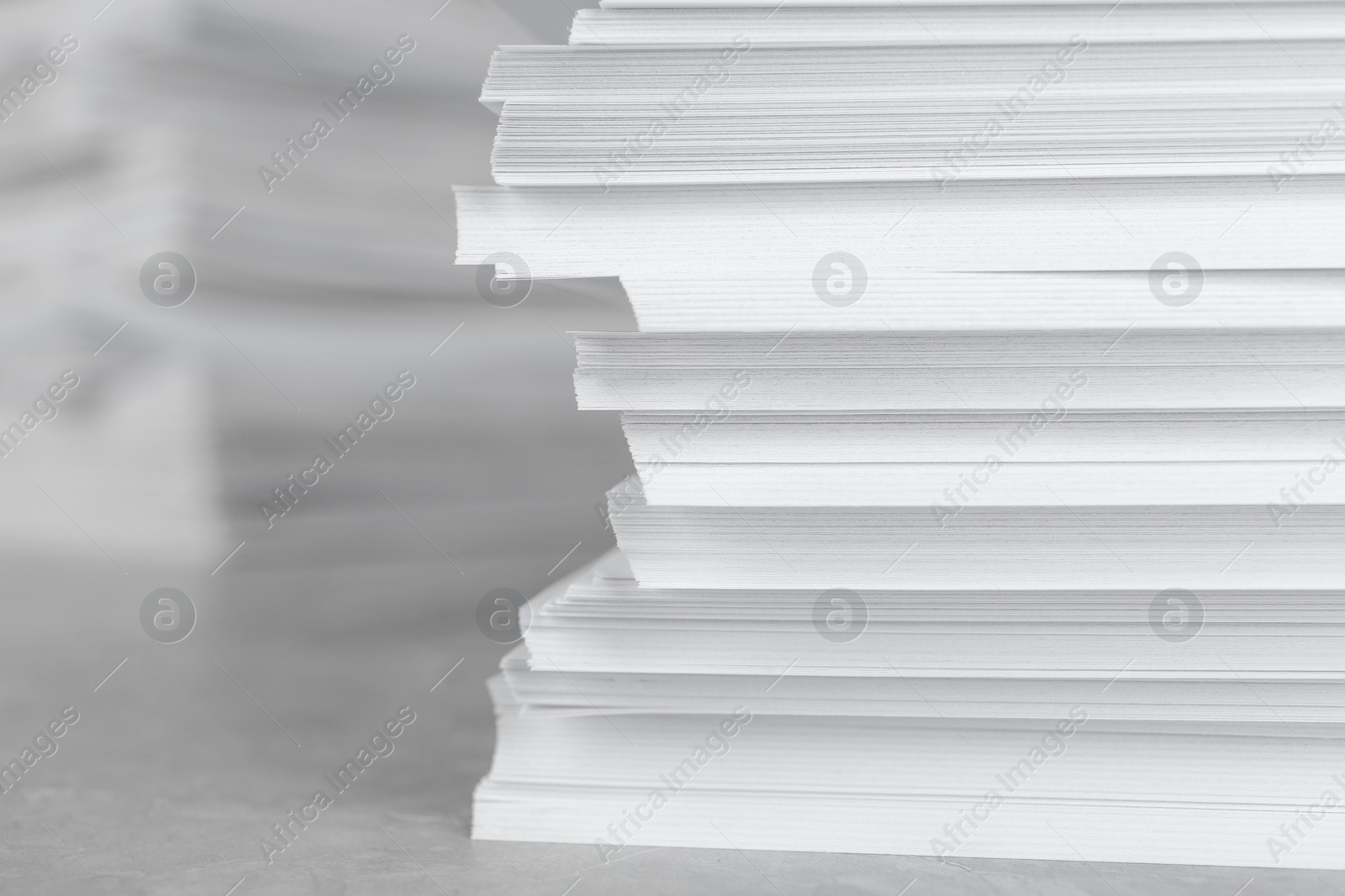 Photo of Stack of blank white paper on table, closeup. Space for text