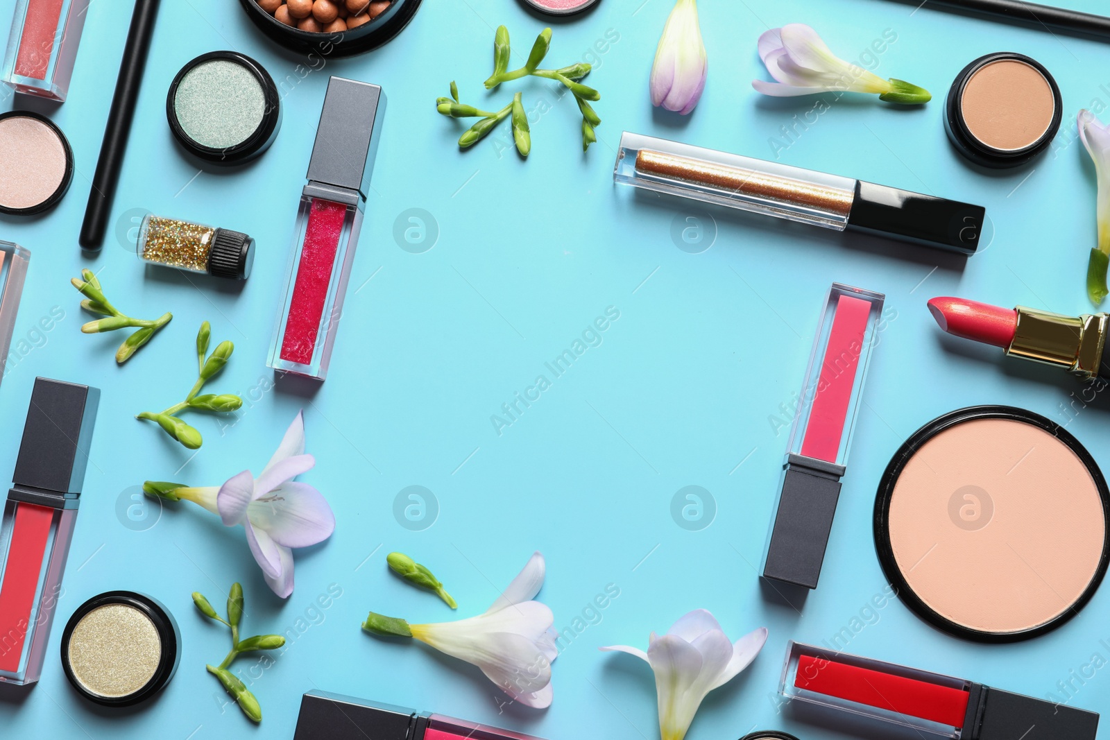 Photo of Different makeup products and flowers on color background, flat lay with space for text