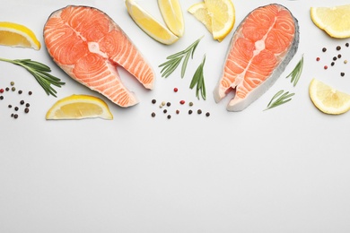 Photo of Flat lay composition with salmon steaks on white background. Space for text