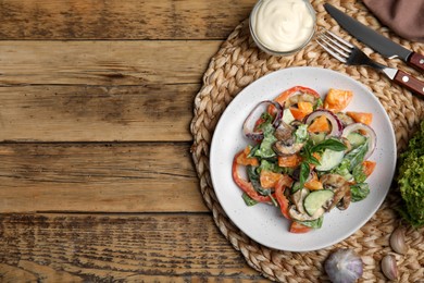 Photo of Delicious salad with mayonnaise served on wooden table, flat lay. Space for text