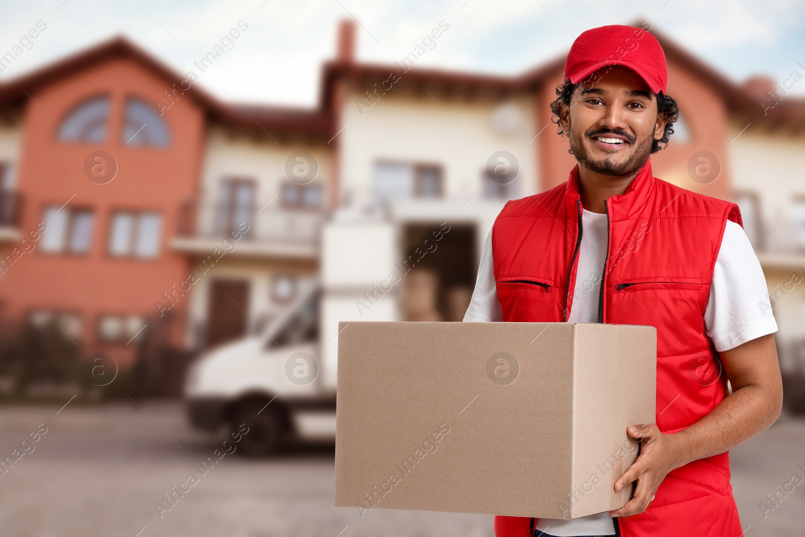 Image of Happy courier with parcel outdoors, space for text