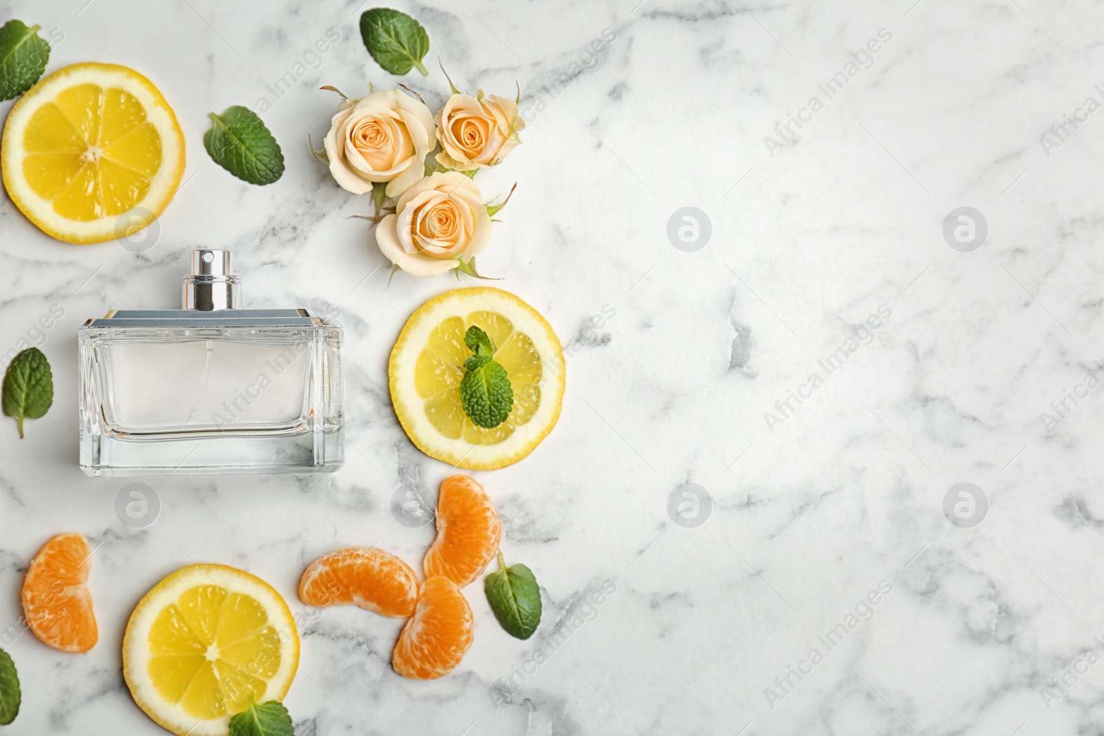 Photo of Beautiful composition with bottle of perfume on light background, flat lay