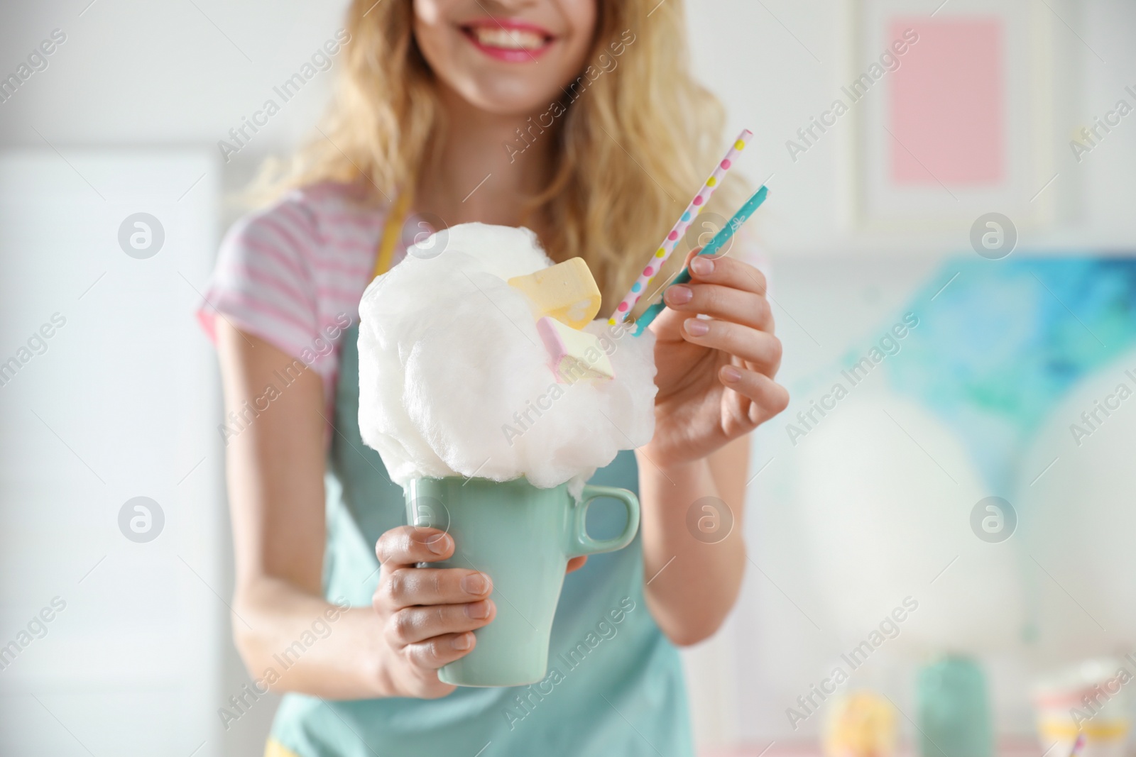 Photo of Young woman with cup of cotton candy dessert indoors, closeup