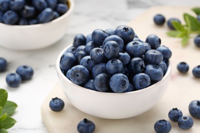 Photo of Tasty fresh blueberries on white table, closeup