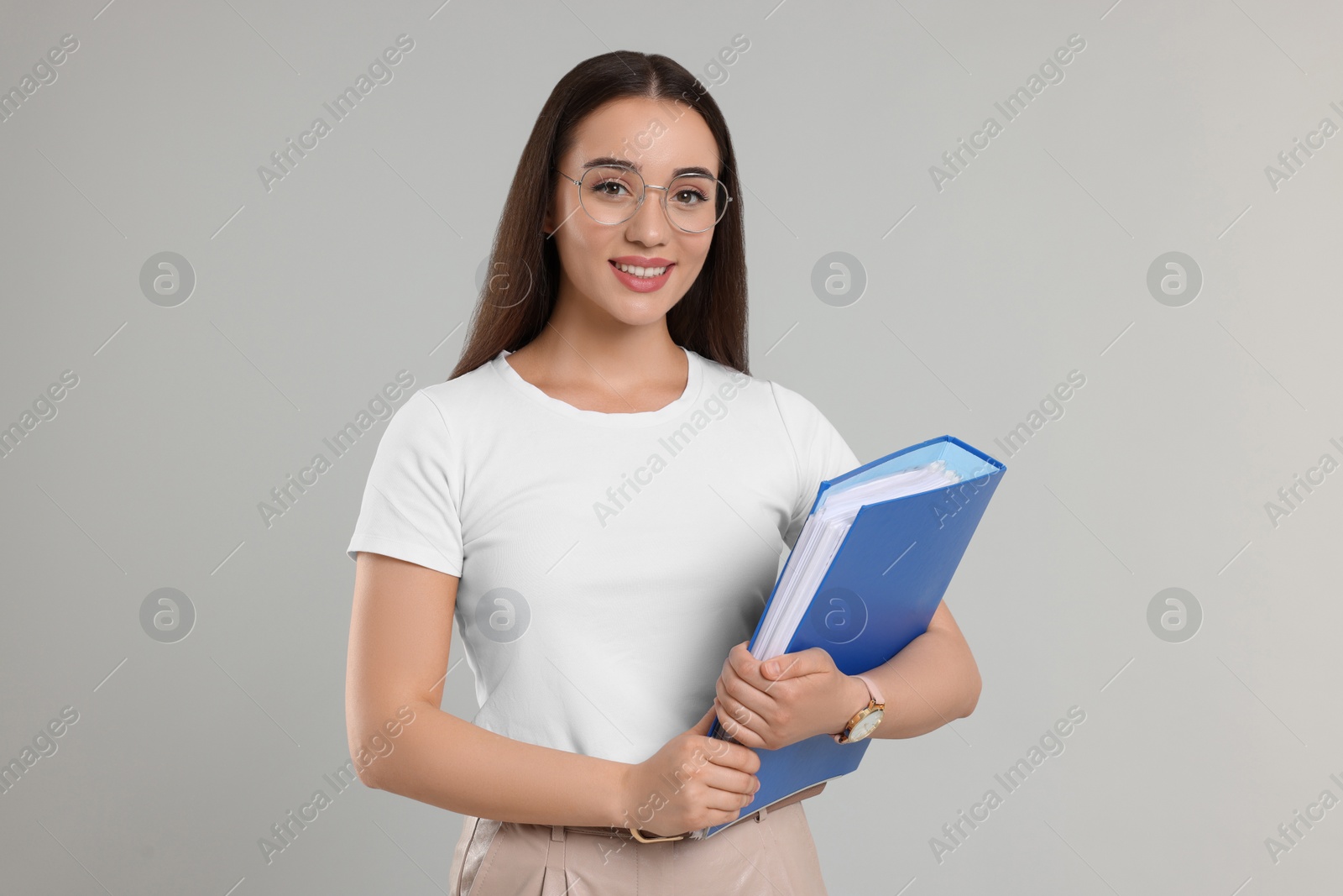 Photo of Happy woman with folder on light gray background