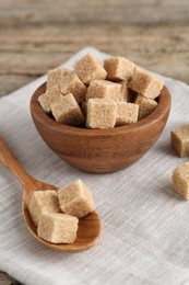 Photo of Many brown sugar cubes on table, closeup